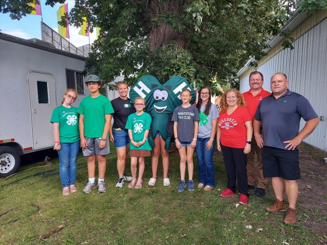 4-H youth and adult leaders posing with Chris Clover, the 4-H mascot.