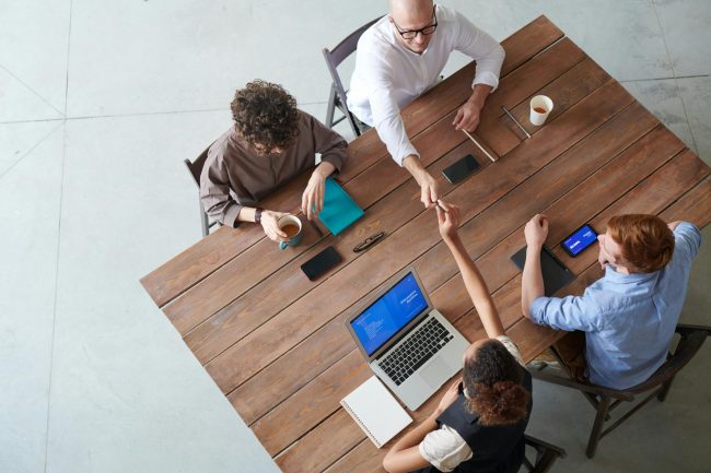 Four people meeting around a table. 