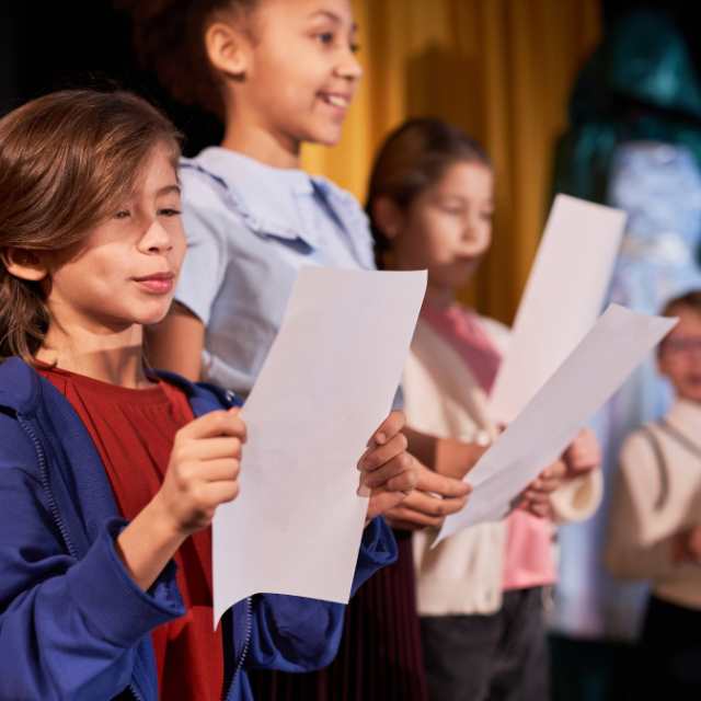 4-h students reading a story telling script for a talent show