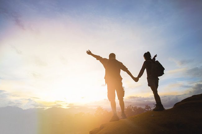 two hikers celebrating