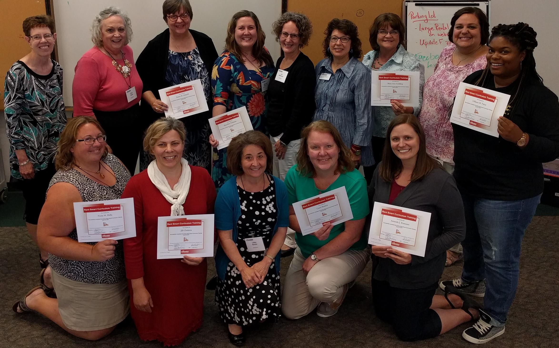 Image of a group of women posed for an image while holding certificates earned from completing the rent smart program